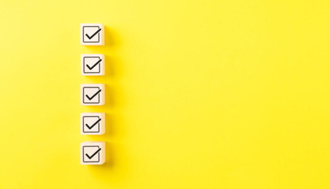 Checklist concept. Correct sign tick check mark on wooden block with copy space for the checklist on yellow background. Business survey questionnaire, Exam test process, filling digital form online,