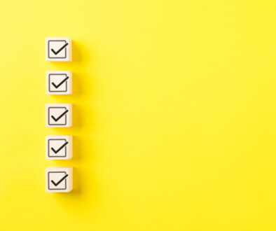 Checklist concept. Correct sign tick check mark on wooden block with copy space for the checklist on yellow background. Business survey questionnaire, Exam test process, filling digital form online,