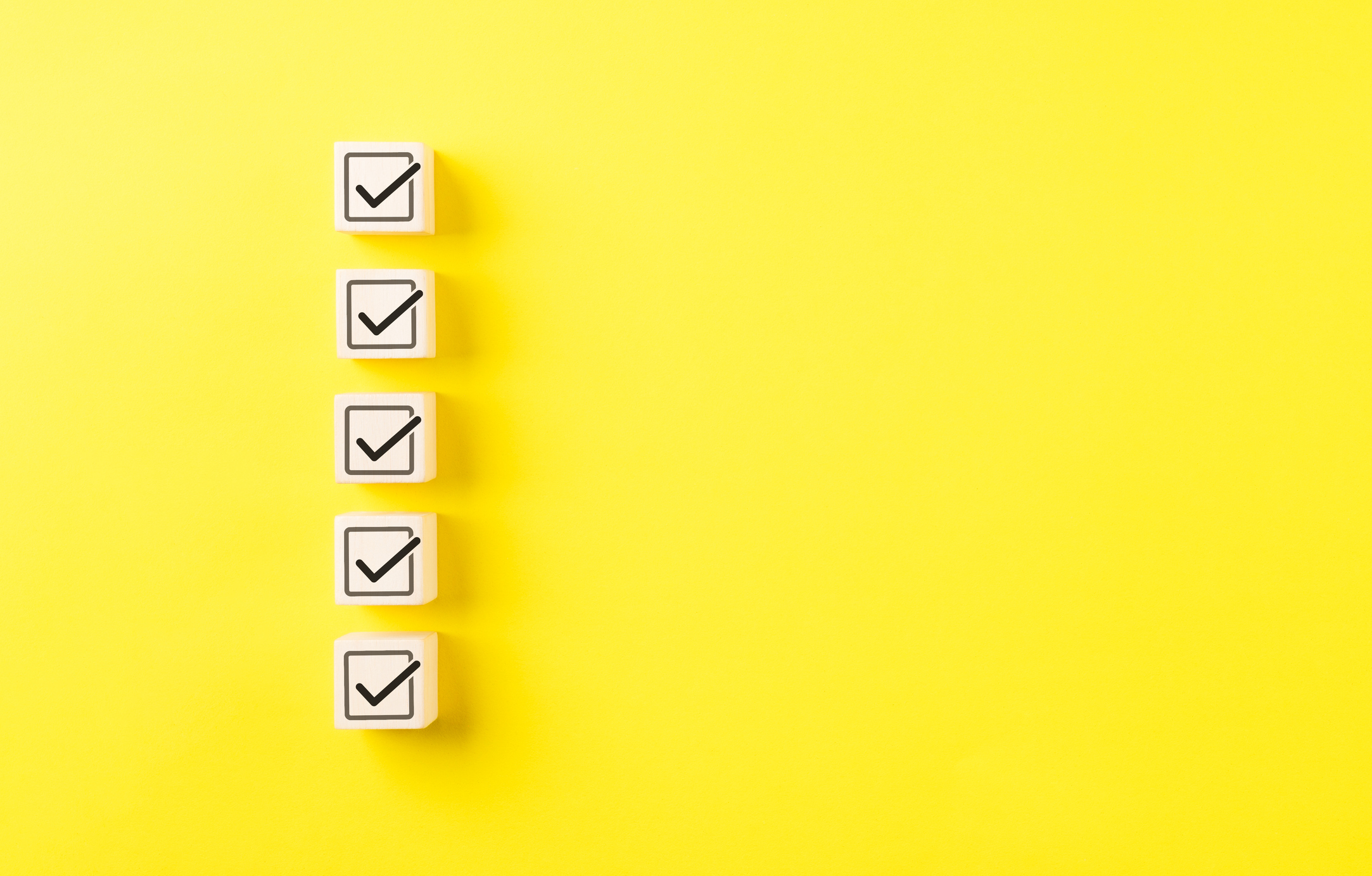 Checklist concept. Correct sign tick check mark on wooden block with copy space for the checklist on yellow background. Business survey questionnaire, Exam test process, filling digital form online, Checklist concept. Correct sign tick check mark on wooden block with copy space for the checklist on yellow background. Business survey questionnaire, Exam test process, filling digital form online,