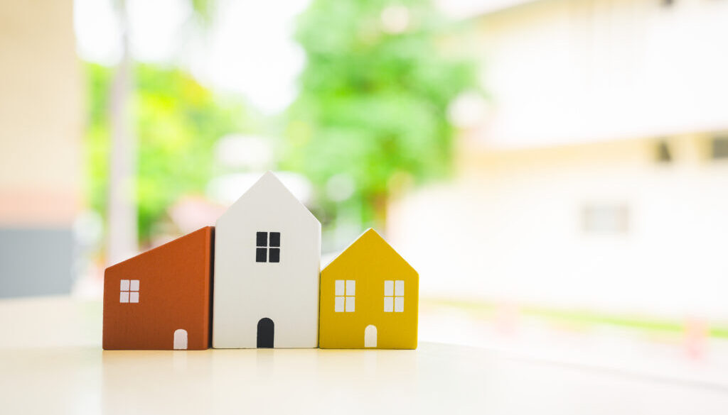 Wood house model on wood table , a symbol for construction , ecology, loan, mortgage, property or home.