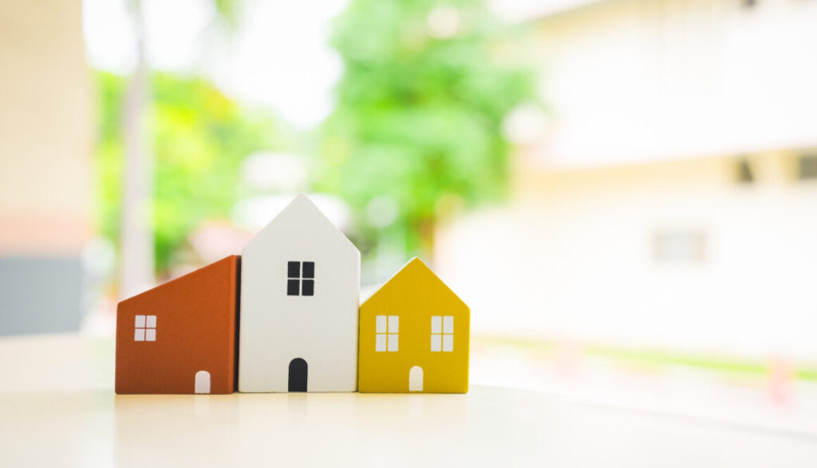 Wood house model on wood table , a symbol for construction , ecology, loan, mortgage, property or home.