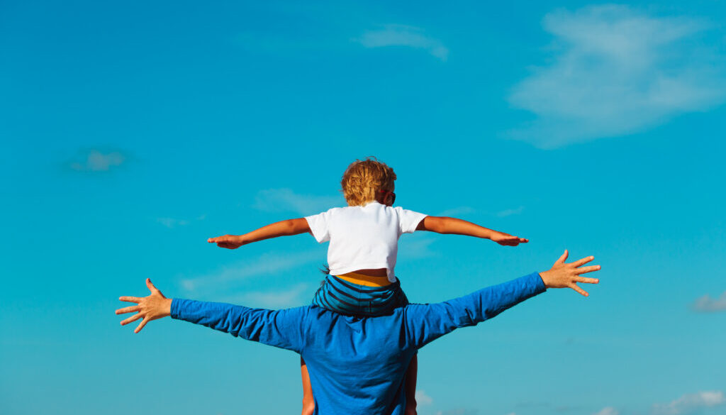 father and son having fun on sky