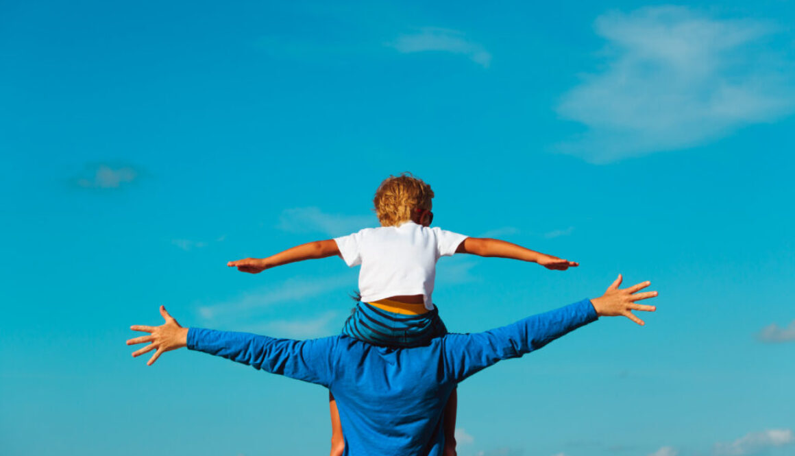 father and son having fun on sky