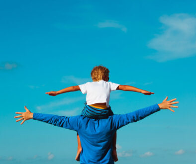 father and son having fun on sky